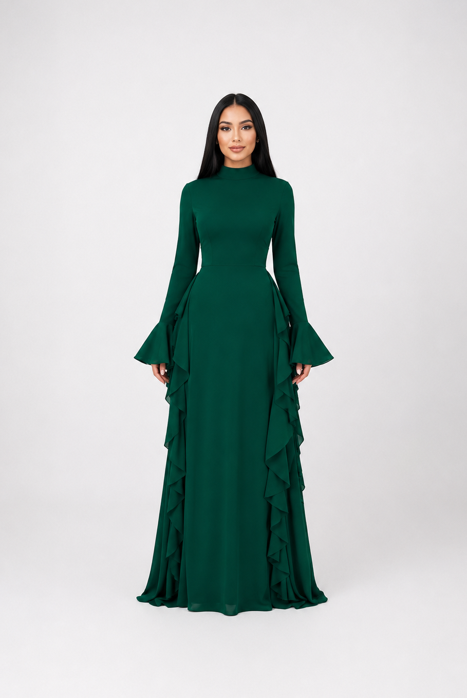 A woman modeling a dark green long-sleeve maxi dress with a high mock neck, flared bell sleeves, and a tiered ruffle skirt, set against a plain light gray studio background.