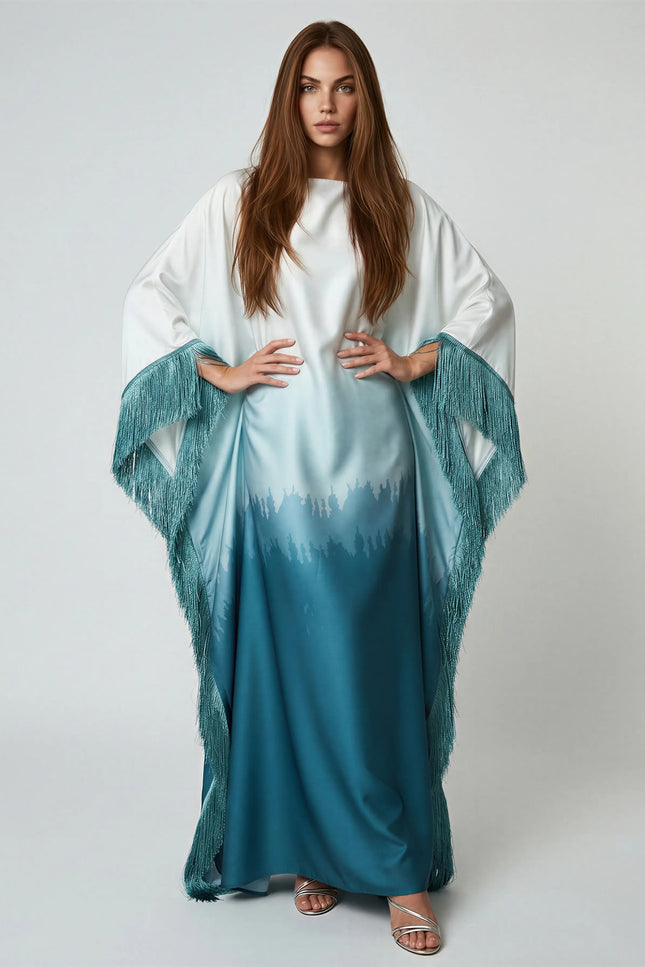 Woman wearing a white and blue gradient dress with a matching shawl on a plain background